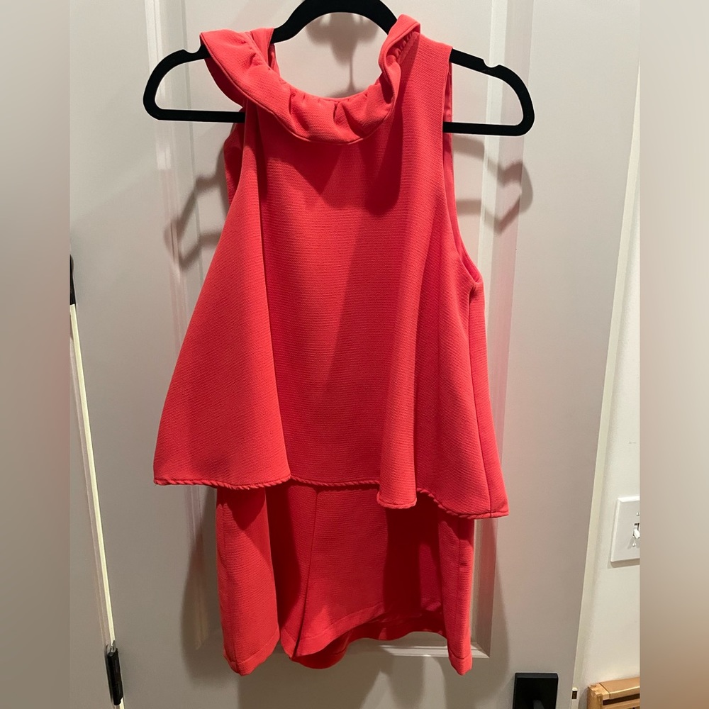 Coral romper worn twice with tie snd ruffle neck line